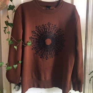 Dark Orange sweater with embroidered design.